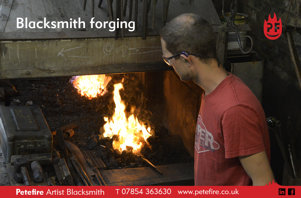 Petefire forge in Chiswell Green, St Albans, Herts, England. Hot forging a piece of metalwork